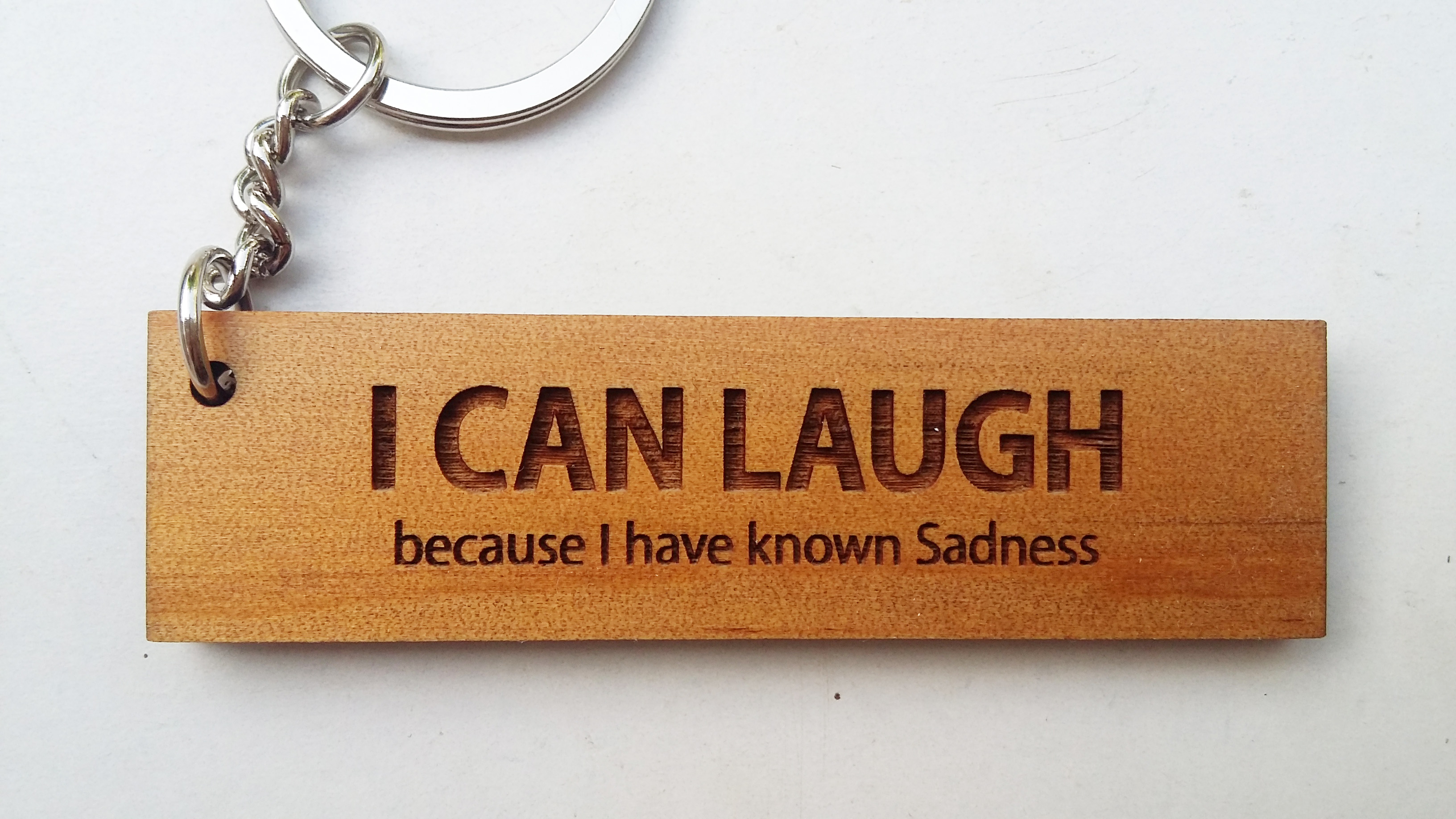 พวงกุญแจไม้ พวงกุญแจไม้ใส่ข้อความ - I CAN LAUGH because I have known sadness