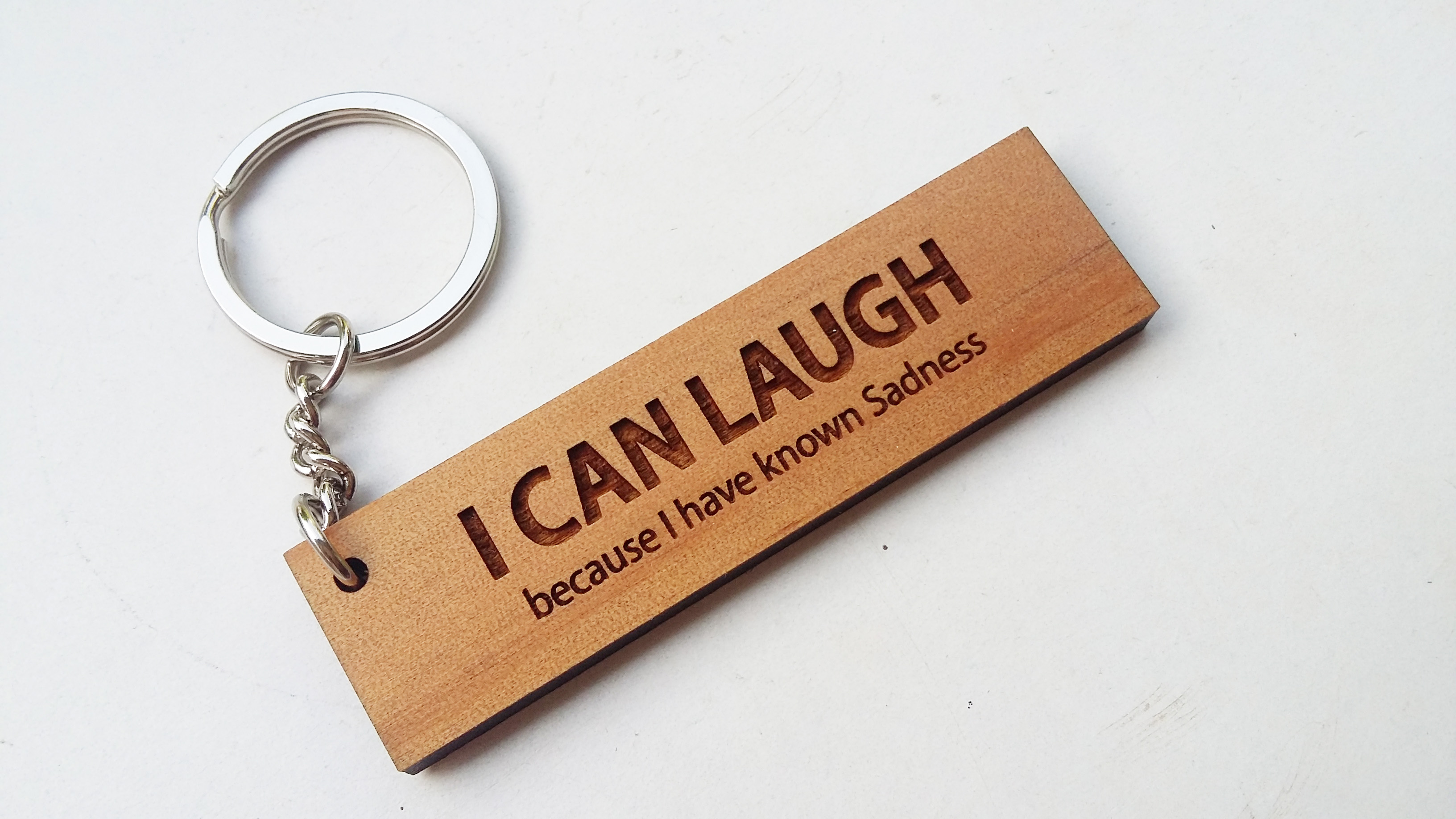 พวงกุญแจไม้ พวงกุญแจไม้ใส่ข้อความ - I CAN LAUGH because I have known sadness