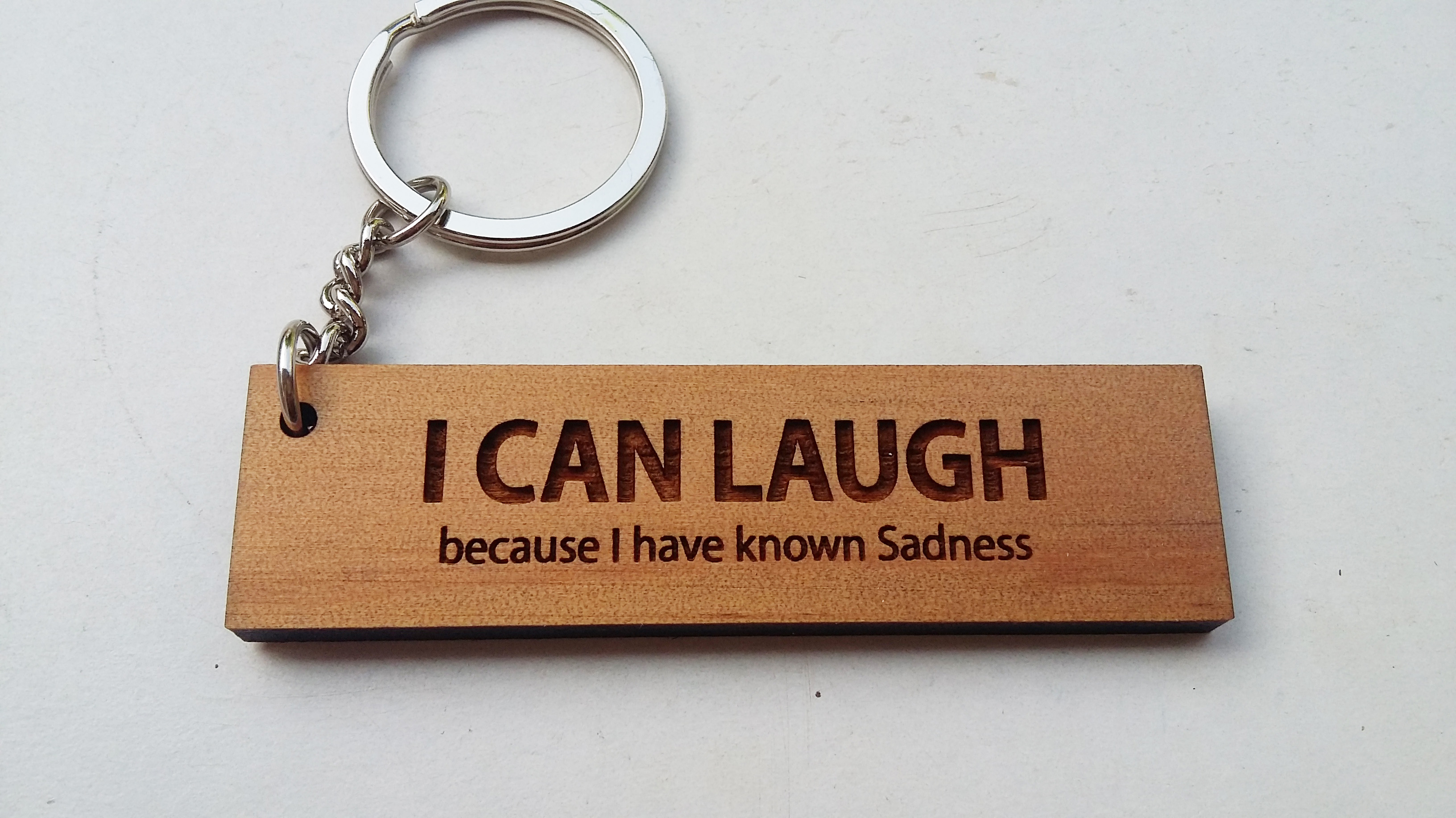 พวงกุญแจไม้ พวงกุญแจไม้ใส่ข้อความ - I CAN LAUGH because I have known sadness