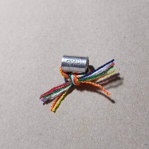 ตะกรุด ลูกอมโลกธาตุ จารมือ เนื้อเงินแท้ (พันด้าย7สี ตอกโค๊ดพยญ.) - หลวงพ่อใจ วัดพระยาญาติ